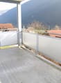 concrete floor, metal railing, view of mountains