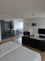 Modern interior, living room, dining area, TV, sofa, chairs, table, kitchen, bedroom