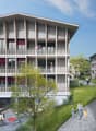 Modern apartment building with multiple balconies, large windows, and a central courtyard.