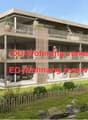 3-storey apartment building with a ground-level terrace and balconies on the first two floors.
