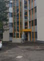 Two story office building with glass wall and entrance