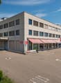 2 story commercial building, red awnings, large parking lot