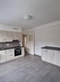 empty kitchen with cabinets, stove, sink, dishwasher, and counter with modern appliances