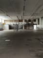 spacious interior, metal staircase, windows, tiled floor, white walls, electrical wires