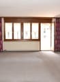 empty room, fireplace, large windows, sliding door, carpeted floor