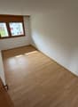 empty room, wooden floors, white walls, window, sun shining in