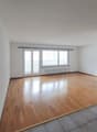 empty room, wooden floor, white walls, sliding glass doors, windows, radiator