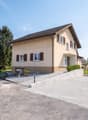 2 story house, brown roof, beige walls, 2 garages, driveway, mailbox