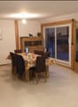 dining table with chairs, flat screen tv, wooden tv unit, white ceiling, tiled floor