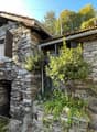 Stone house, wooden roof, wooden door, garden, mountain view