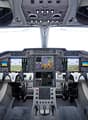 Cockpit dashboard with monitors, control panels, switches, and gauges.
