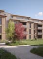 3 story building, wooden facade, balconies, common outdoor space
