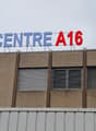 A multi-story commercial building with the sign 'CENTRE A16' displayed prominently on the facade.