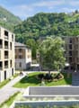 Modern apartment buildings, green space, walking paths, trees, mountains in the background