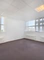 Office: empty room, white walls, white ceiling, grey carpet, windows, two white radiators