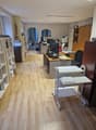 Modern office with desks, computers, bookshelves, and storage units, parquet flooring, office equipment