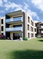 Modern apartment building with multiple balconies, beige exterior, large windows, surrounded by greenery