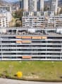 Aerial view of a multi-story residential building with multiple balconies and terraces.