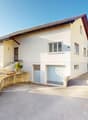 2 story house, white walls, brown roof, driveway, garage, staircase