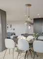 Open-concept living room and kitchen with large windows, gray curtains, round dining table with white chairs, gray sofa, black kitchen cabinets, and pendant lighting fixtures.
