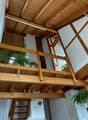 wooden ceiling, wooden floor, balcony with wooden railing and plants