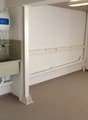 Empty room with a sink, pipes, and a water heater