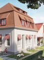 A row of white houses with brown roofs, each with multiple windows and awnings, a pathway in front, and a bicycle parked nearby.