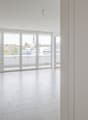 empty room, white tiles, large sliding glass doors, balcony, city view