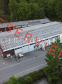Industrial building with multiple parking spaces in front