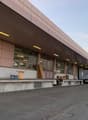 modern industrial building, metal awning, loading dock, truck in front