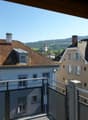 balcony, brown roof, windows, view of town