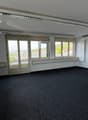 empty room, white walls, black carpet, large windows, air conditioning unit