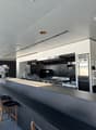 modern commercial kitchen, stainless steel appliances, tiled backsplash, commercial oven, refrigerator