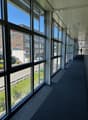 hallway with glass walls, windows with view to the outside