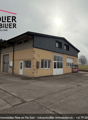 2 story house, concrete walls, white doors, garage, windows, cloudy sky