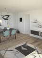 Open-concept living room and kitchen with white walls, hardwood floors, a dining table with four chairs, a black TV stand, a gray sofa, and a modern kitchen with a dishwasher.