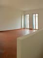 tiled floor, white walls, large windows, balcony