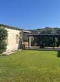 House with outdoor sitting area and pergola, garden, climbing plants on the wall, outdoor table and chairs, swing, lawn