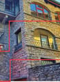 stone building, multiple floors, balconies, arched windows, staircase, wall, metal railings