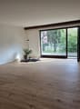 empty room, wooden floor, white walls, sliding glass door, balcony, potted plant, lamp