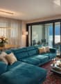 turquoise sofa, wooden table, dining chairs, glass doors, balcony, lake view
