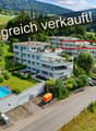Three-story apartment building, swimming pool, parking spaces, fenced yard, trees