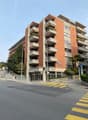 residential building with balconies, orange exterior, modern architecture