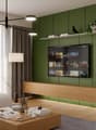 Modern living room with green accent wall, large TV display, wooden media console, pendant lighting, and a coffee table with books and decor