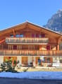 wooden chalet style house, 3 stories, balcony, mountain view