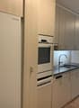 kitchen with wooden cabinets, granite countertop, sink, oven, dishwasher, fridge