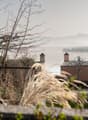 Overlook of a building, with a view of a lake and mountains.