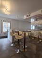modern bar counter, white leather chairs, tiled floor, white walls, modern lighting