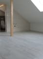 empty room, white tiles, wooden floor, skylight, toilet, small window