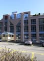 4 story building, windows, parking, car driveway